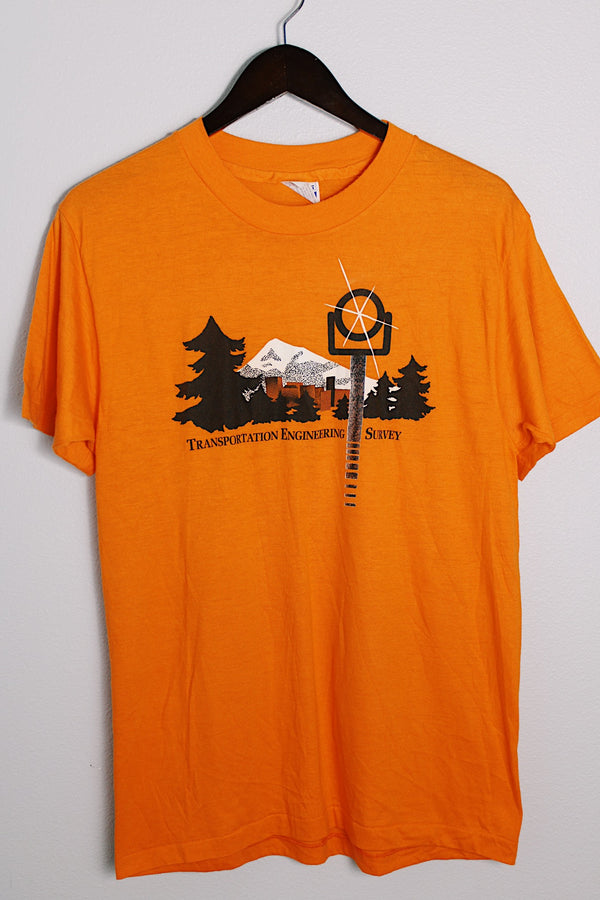 Women's or men's vintage 1980's Hanes, Fifty-Fifty, Made in USA label short sleeve orange tee with graphic on the front in black and white in a Polyester and cotton material. 