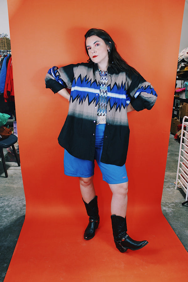 Men's vintage 1980's Express Rider label long sleeve button up shirt with a black, blue, and beige Western style print.