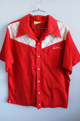 Men's or women's vintage 1970's King Louie label short sleeve red button up bowling shirt. Embroidered name on the front, graphic on the back, white and red striped buttons.