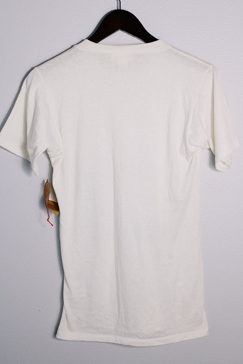 Women's or men's vintage 1986 Coca-Cola label short sleeve white tee with graphic on the front in a polyester and cotton material.