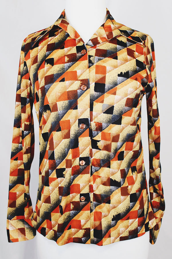 Women's vintage 1970's long sleeve button up shirt with dagger collar and all over brown and orange abstract print. 