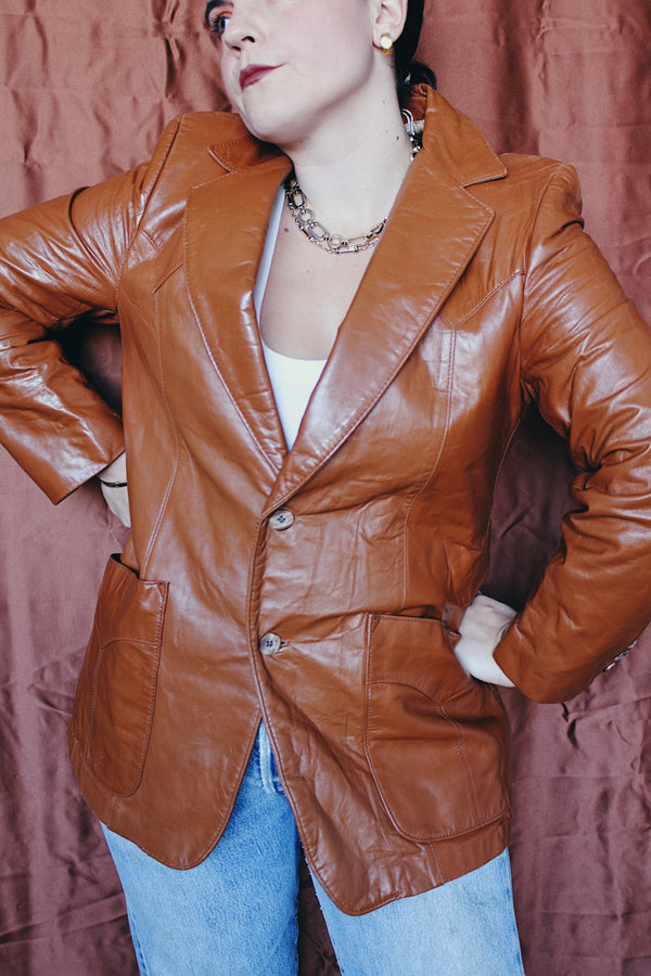 Women's or men's vintage 1970's Cresco label camel brown colored leather blazer jacket with two button closure and two front pockets.