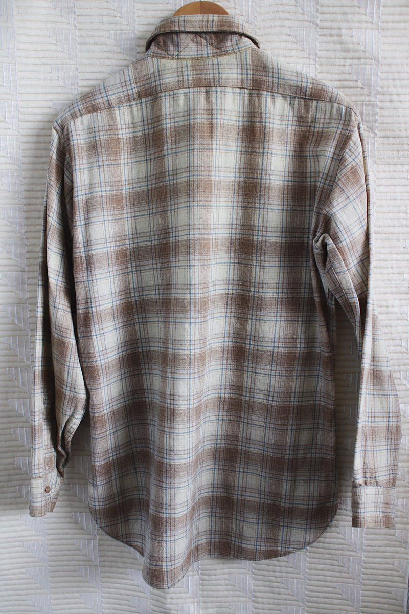 Men's vintage 1970's Pendleton label medium long sleeve button up plaid wool shirt in cream and brown colors. Two chest pockets. 