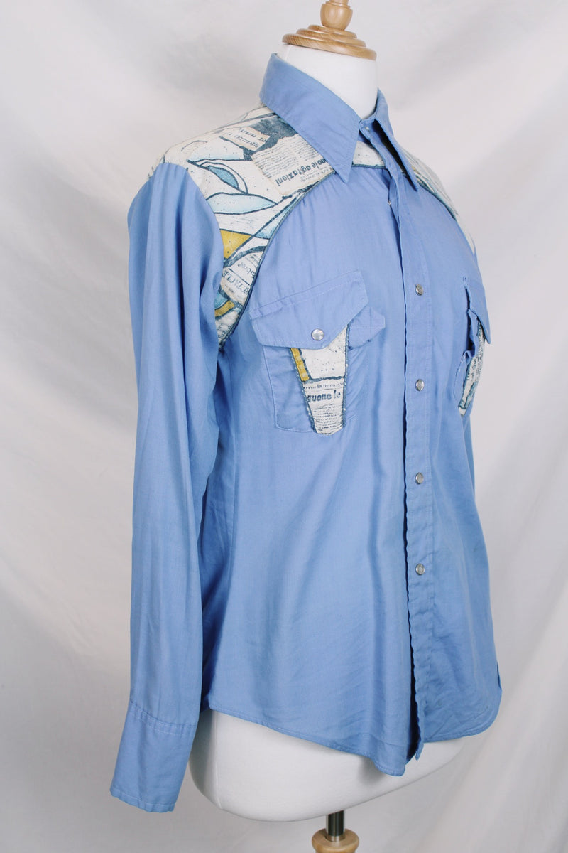 Men's vintage 1970's long sleeve button up blue colored shirt with patchwork detail throughout. Pearl snapper buttons up the front.