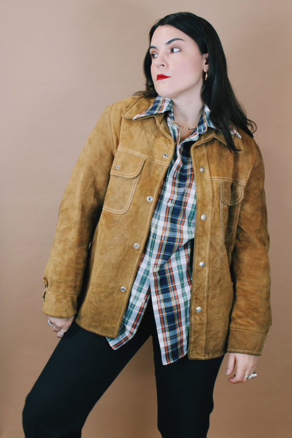 Men's or women's vintage 1970's Genuine Leather label size medium long sleeve light tan brown suede western style jacket with popper buttons. 