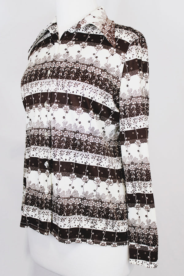 Women's vintage 1970's long sleeve button up blouse with dagger collar in white and chocolate brown colors with all over ditsy floral print.