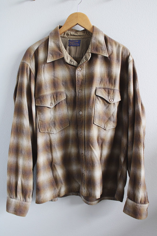 Men's vintage 1970's Pendleton label size XL long sleeve button up wool shirt in all over cream and brown plaid print. Two chest pockets.