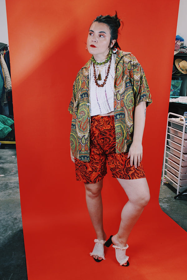 Women's or men's vintage 1960's Don Soper of California label short sleeve button up shirt with collar. All over paisley print in green, yellow, and orange.