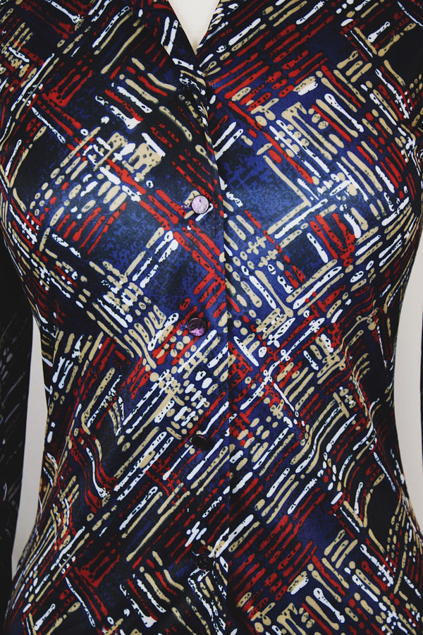 Women's vintage 1970's long sleeve button up blouse with a dagger collar in a navy blue color and all over abstract print. 