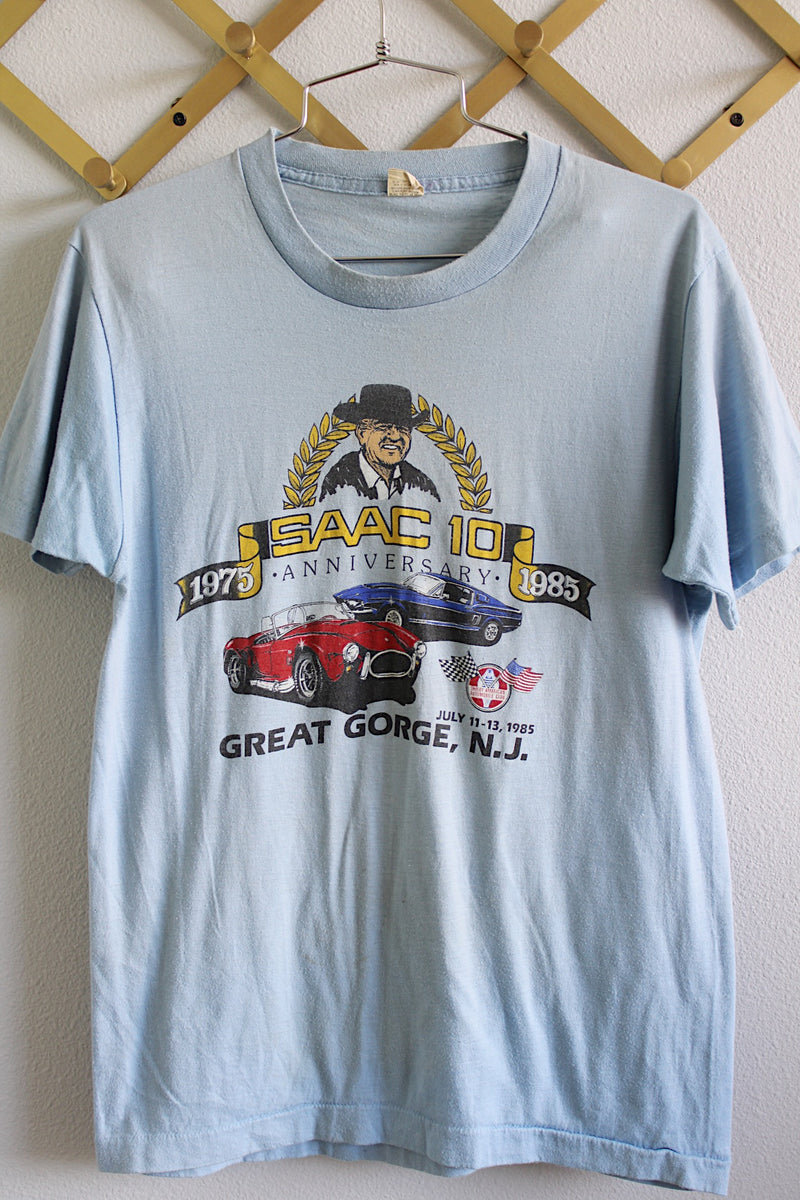 Women's or men's vintage 1980's Screen Stars, Made in USA label short sleeve baby blue tee with car racing graphic on the front from 1985.