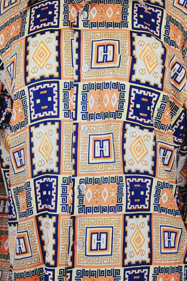 Men's vintage 1970's Envoy label long sleeve button up shirt with dagger collar with all over orange and navy abstract print. 