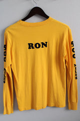 Men's or women's vintage 1980's long sleeve yellow t-shirt with graphic and text on front, back, and on arms in a cotton material. 