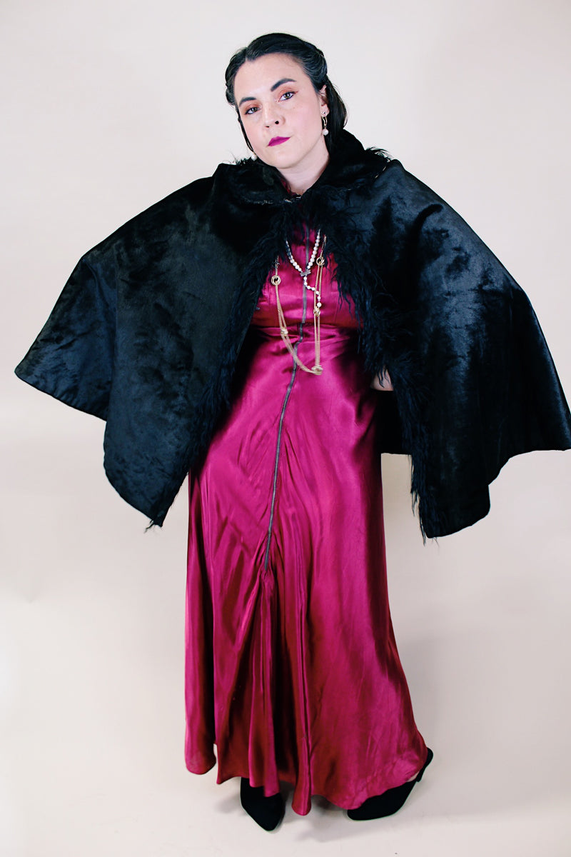 Women's vintage possibly 1940's black colored pony fur large cape poncho with fur trim around the edges. Has a closure at the neck and the peter pan collar and fully lined.
