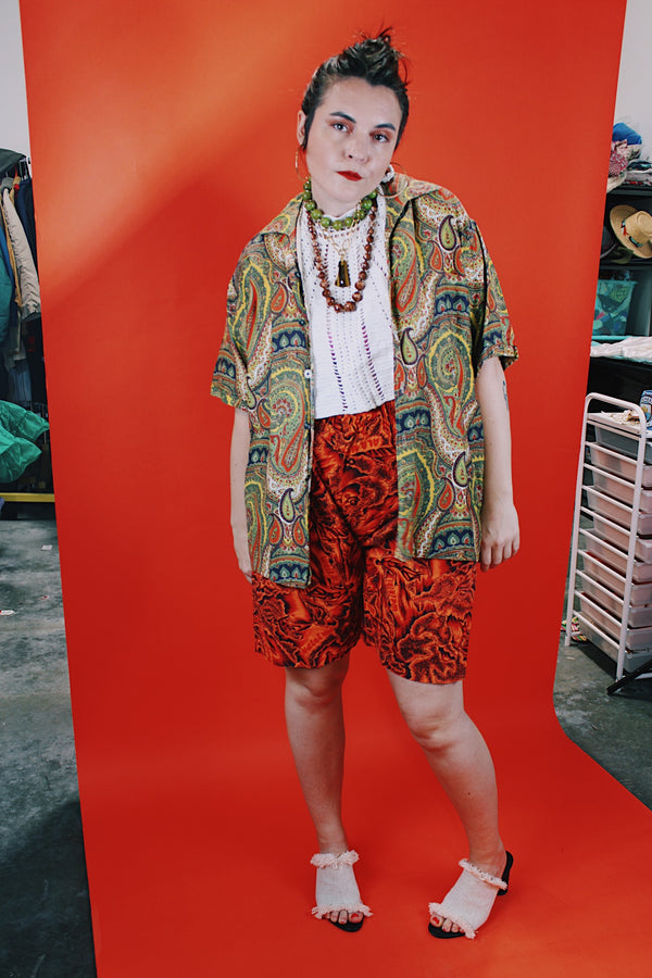 Women's or men's vintage 1960's Don Soper of California label short sleeve button up shirt with collar. All over paisley print in green, yellow, and orange.