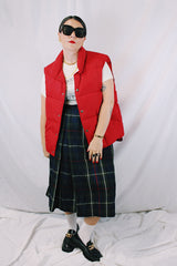 Men's or women's vintage 1980's Woolrich, Made in USA label sleeveless cherry red puffer vest. Popper buttons up the front and two pockets.