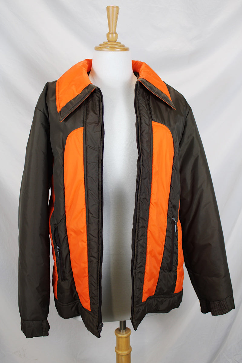 Women's or men's vintage 1970's Cascade, Made in Korea label long sleeve zip up brown and orange colored nylon puffer jacket.