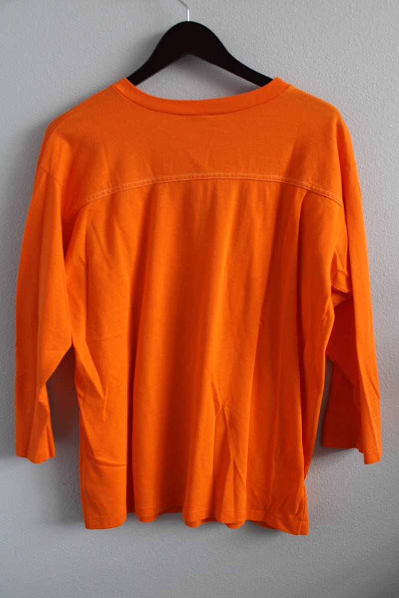 Women's or men's vintage 1970's Artex, Made in USA label long sleeve bright orange t-shirt with white text and graphic on front in cotton material. 