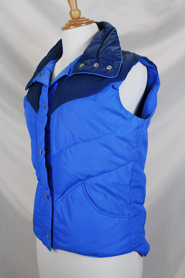 Women's vintage 1980's Tempco, Down Insulated, By Tempco Quilters Seattle, Made in USA label sleeveless navy and blue nylon puffy vest with popper buttons. 