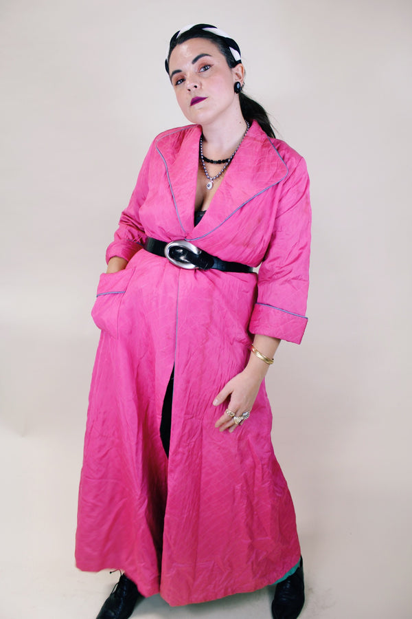 Women's vintage 1950's Lyn Delle label long sleeve long length bright pink quilted robe jacket with teal colored trim. 