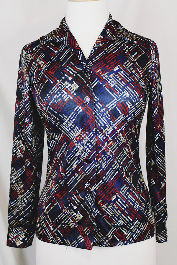 Women's vintage 1970's long sleeve button up blouse with a dagger collar in a navy blue color and all over abstract print. 