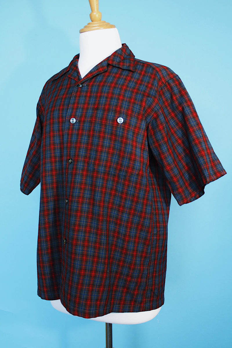 Men's vintage 1960's Pendleton short sleeve button up plaid shirt in a lightweight wool material. Red and grey colors with one chest pocket.