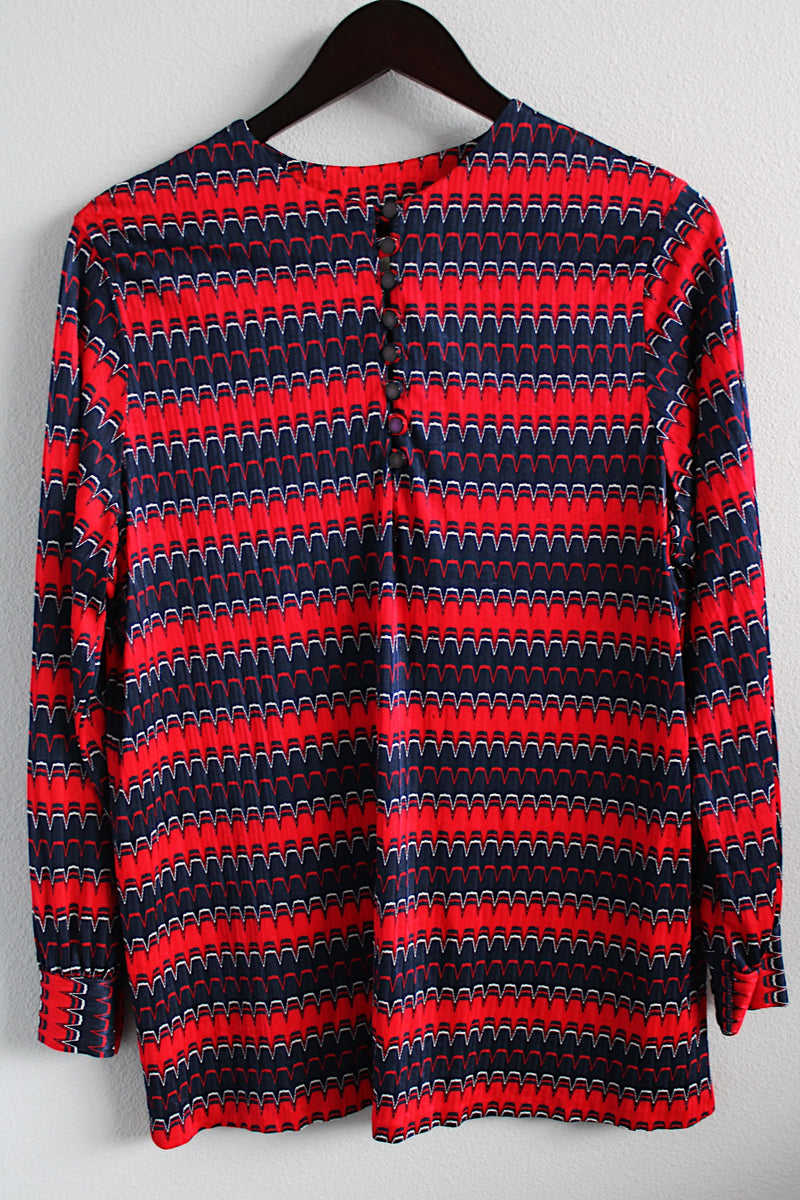 Women's vintage 1970's long sleeve red and navy colored striped zig zag top with half button front closure in a slinky polyester material.