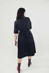 vintage 1950's paisley printed midi length dress with 3/4 arms and button up bust with small collar dark green back