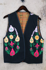 Women's vintage 1970's sleeveless black cotton vest with floral embroidery on the front and multicolors on the back