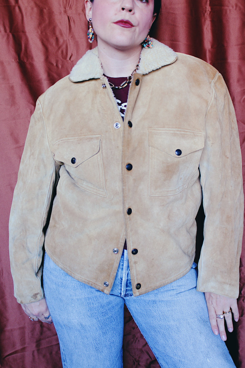 Women's or men's vintage 1950's Alaska Sleeping Bag Co., Portland, Oregon label long sleeve tan colored suede jacket with popper buttons and cream shearling liner.