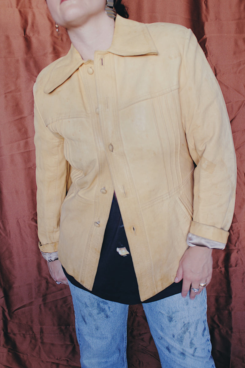 Women's or men's vintage 1970's Styled by Scully in Los Angeles long sleeve long length tan camel colored leather jacket with leather buttons up the front.