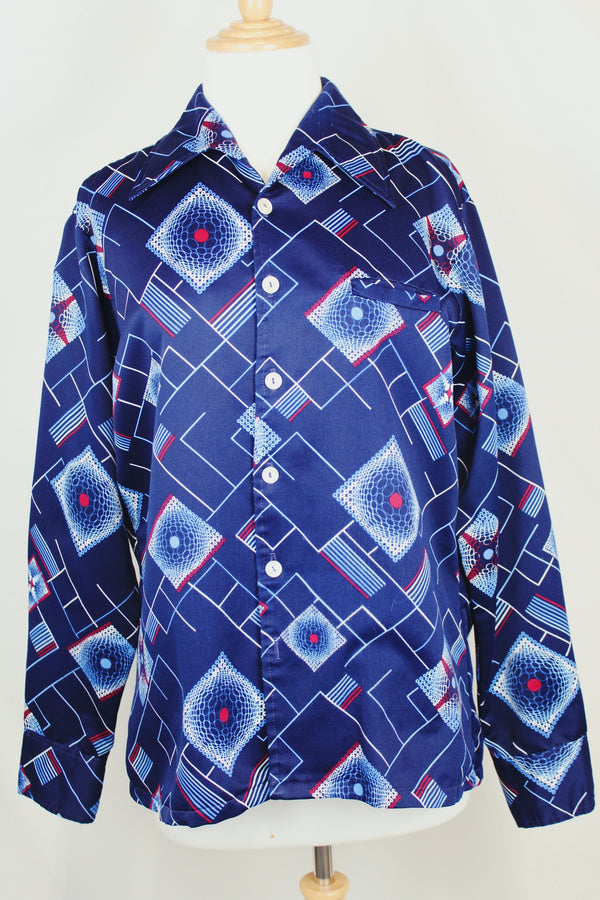 Men's vintage 1970's Da Vinci Presents Delfina label long sleeve vibrant navy blue button up shirt with all over white and red abstract print in thick polyester material. 