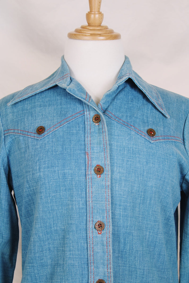 Women's vintage 1970's long sleeve medium wash denim chambray button up blouse with red contrast stitching and brass buttons. 
