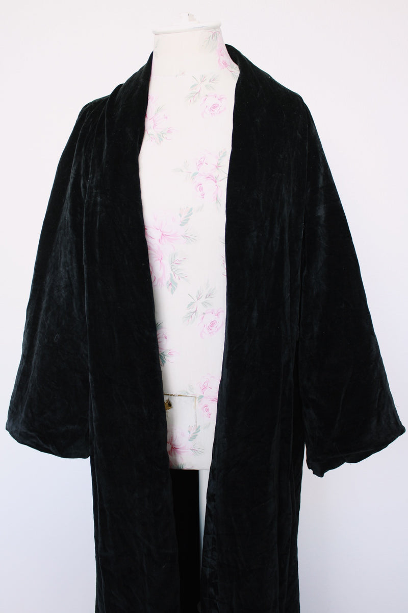Women's vintage 1960's ankle length long sleeve black velvet duster jacket. Fully lined and has two side pockets.