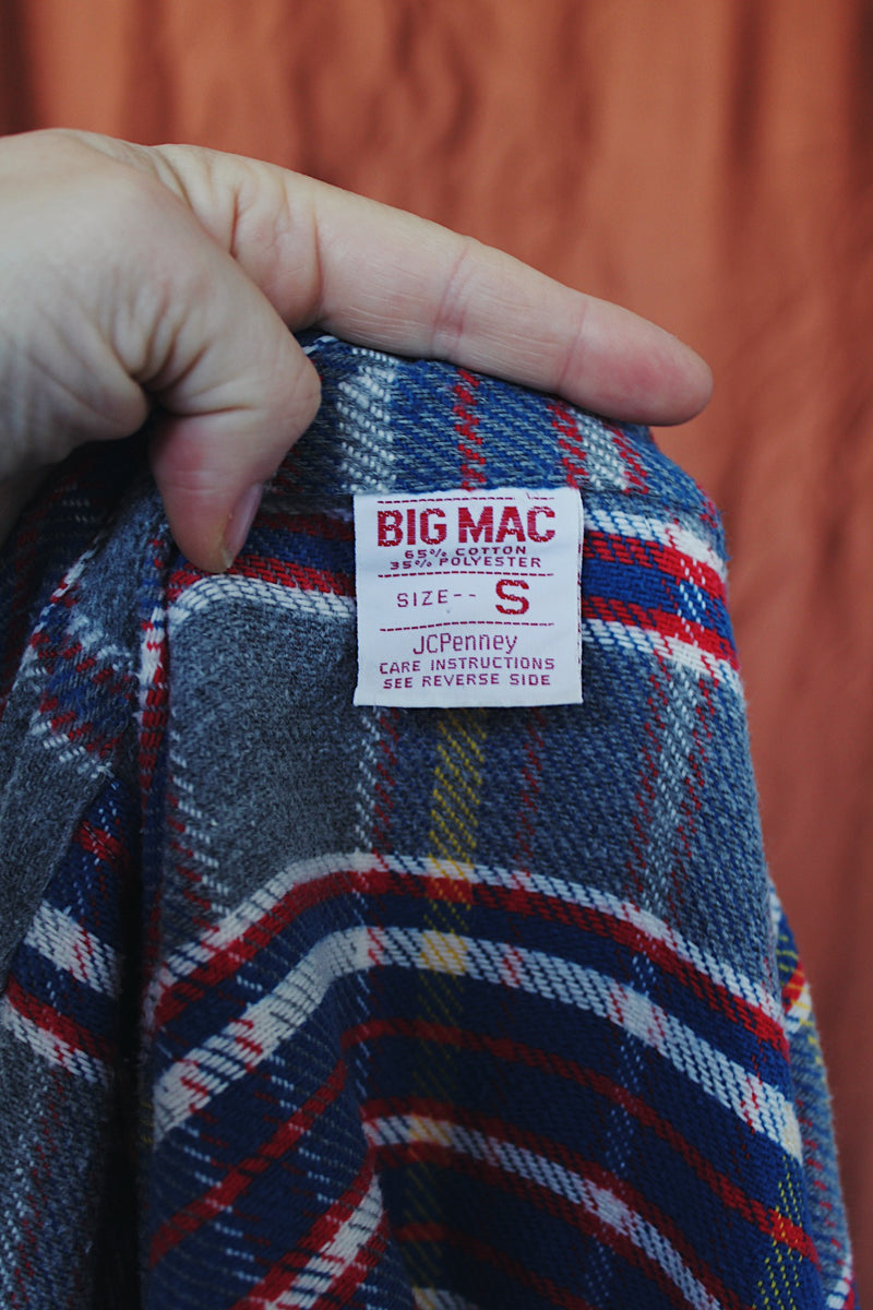 Men's or women's vintage 1970's Big Mac label long sleeve plaid button up flannel shirt in blue, grey, red, and yellow with white buttons.