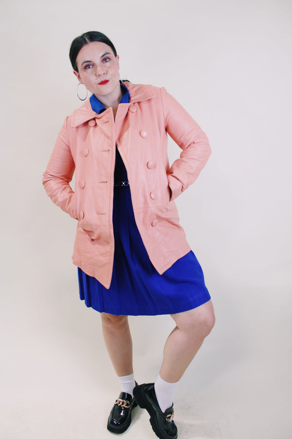 Women's vintage 1970's peach pink colored leather double breasted pea coat. Double lapel, pockets, and fully lined. 