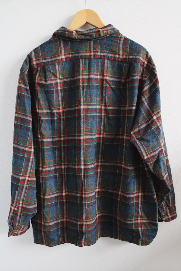 Men's vintage 1970's Pendleton label long sleeve wool button up shirt in size XL. Blue and red plaid all over print. Two chest pockets. 