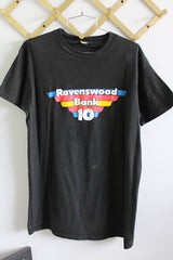 Women's or men's vintage 1970's Screen Stars label short sleeve black t-shirt with multi-colored graphic and text on the front. Cotton material.