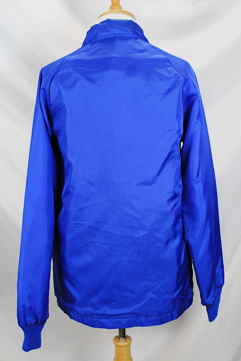 Women's or men's vintage 1980's Swingster, World of Wearables label long sleeve lightweight bright blue nylon windbreaker jacket with logo on left chest, popper buttons, and furry fleece liner.
