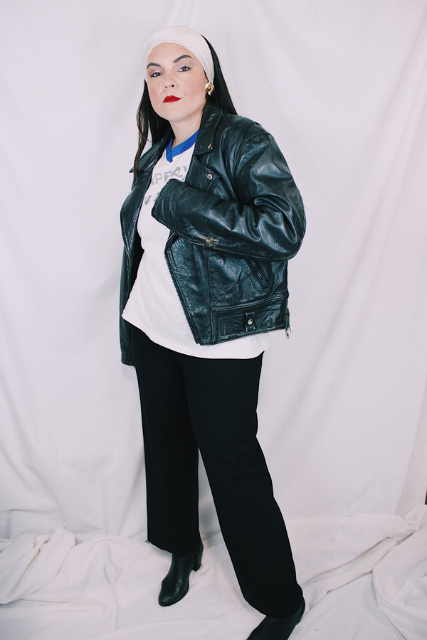Men's or women's vintage  1970's Genuine Leather, Made in Mexico label long sleeve black leather moto leather jacket with silver hardware. 