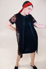 Women's vintage 1960's short sleeve mini length black dress with lace overlay and ribbon trim and bow. Zipper in the back. 