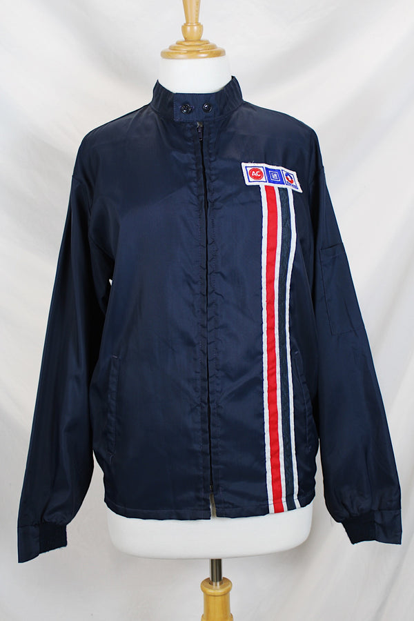 Men's or women's vintage 1980's Horizon Sportswear Inc., Made in USA label long sleeve navy blue nylon zip up windbreaker jacket with red and white vertical stripe down the front and patches.