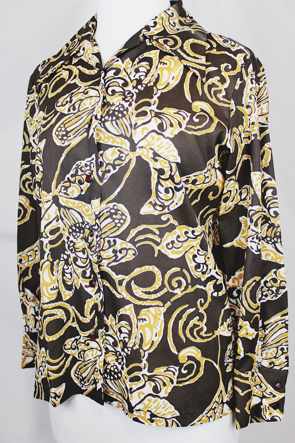 Women's vintage 1970's long sleeve button up blouse with a dagger collar in chocolate brown and tan colored all over abstract print.