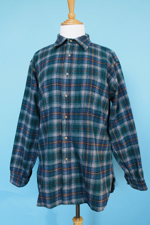 Men's vintage 1980's Pendleton, Made in USA label long sleeve plaid print button up shirt with tan elbow pads. Green and blue colors in a wool material.