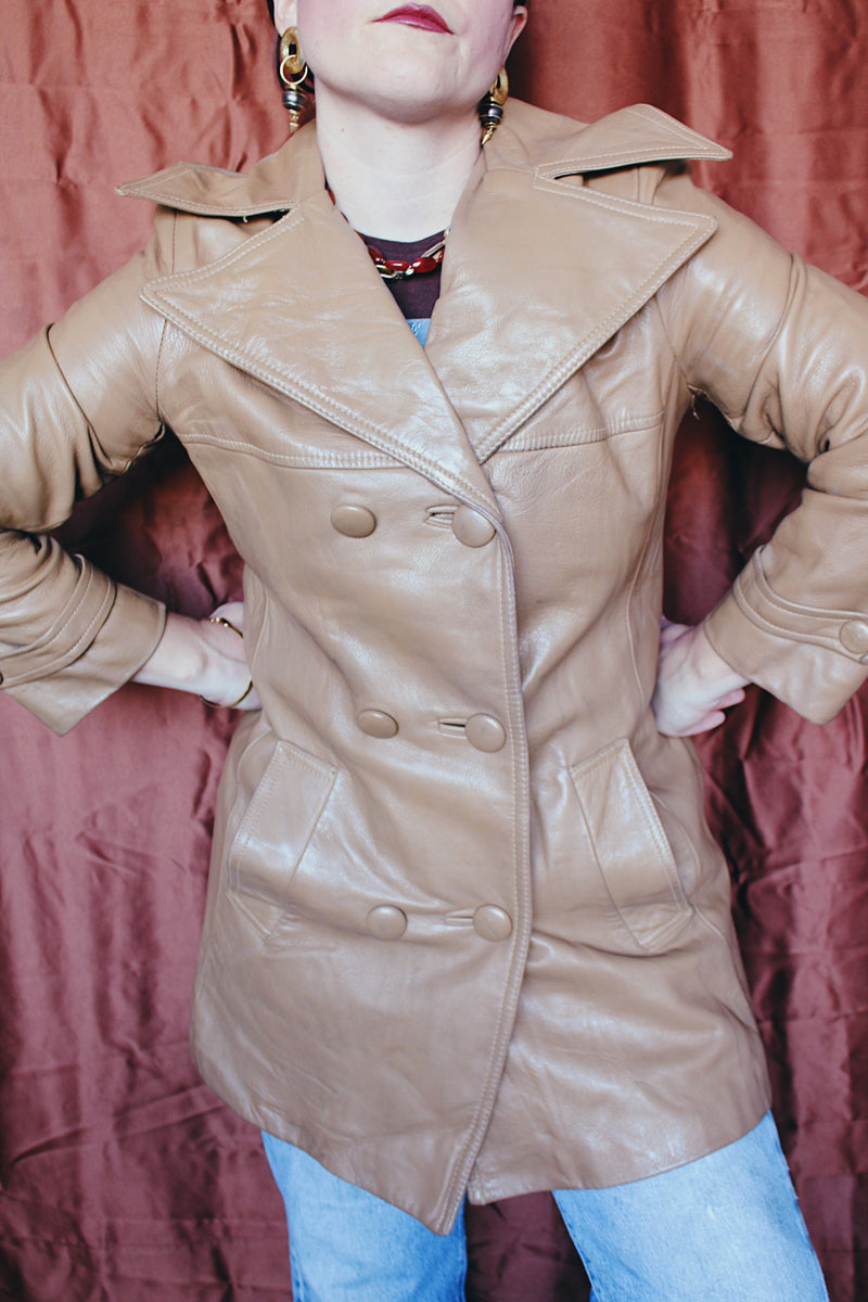 Women's vintage 1970's Nordstrom label long length long sleeve tan brown colored double breasted leather trench coat.