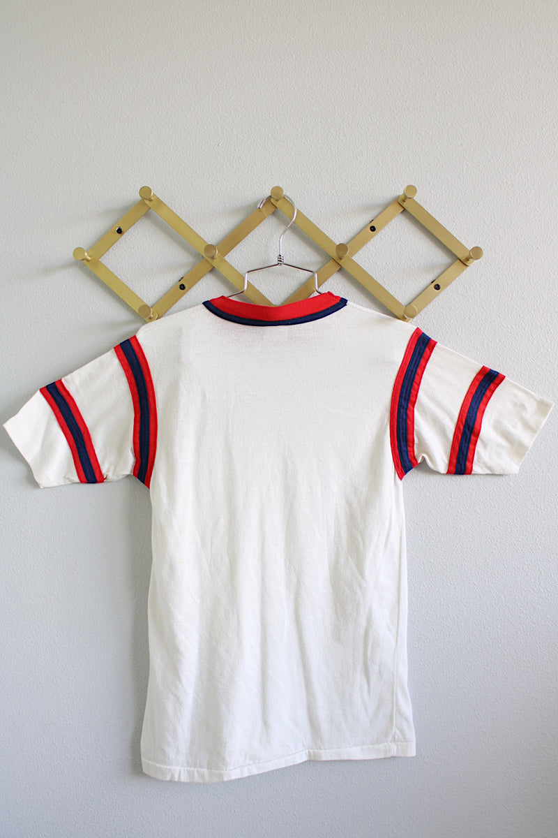 Women's or men's vintage 1980's Bantams label short sleeve white ringer tee with red and navy trim on arms and neckline. Sea lion coves Oregon Coast graphic on left chest.