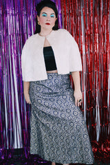Women's vintage 1970's maxi length navy blue skirt. Skirt has an all over silver and gold embroidered metallic pattern. 