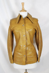 Women's vintage 1970's Made in Belgium label long sleeve light tan colored leather lightweight jacket with silver snap buttons and a dagger collar.