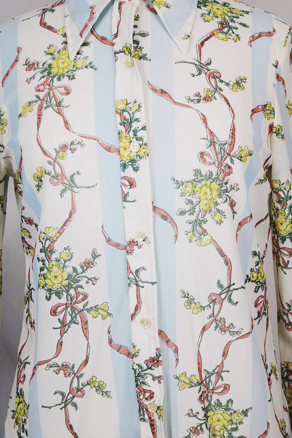 Women's vintage 1970's Knit Editions by Ship 'n Shore long sleeve button up blouse with a dagger collar in an all over white and blue stripes pattern and floral print. 