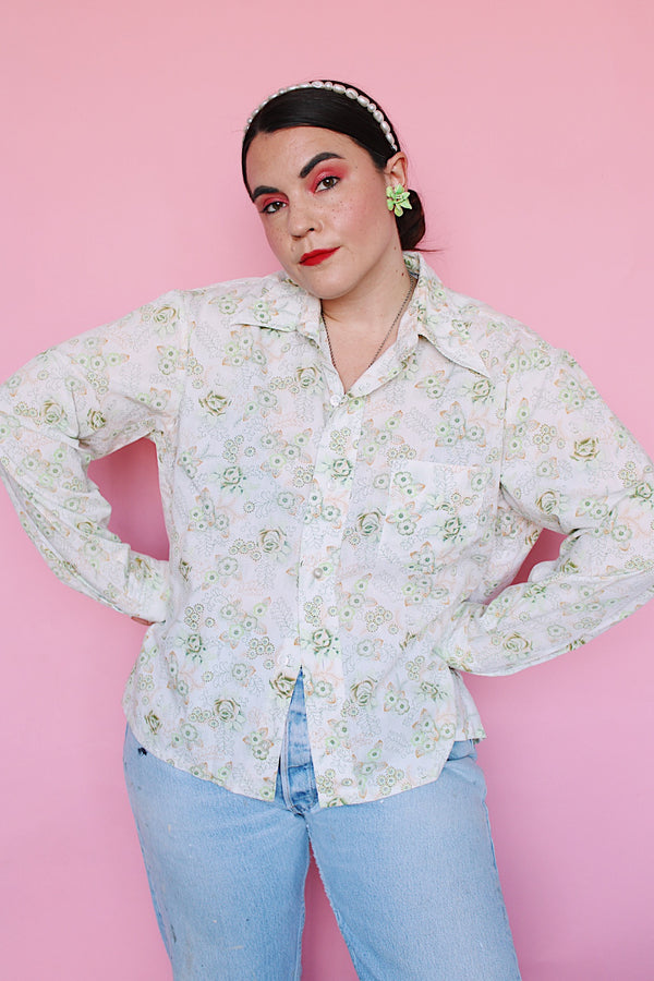 Men's or women's vintage 1970's Sutton Place label long sleeve button up shirt in white with all over green floral print. 