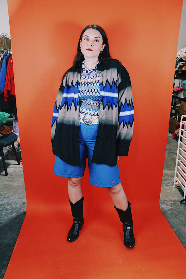 Men's vintage 1980's Express Rider label long sleeve button up shirt with a black, blue, and beige Western style print.